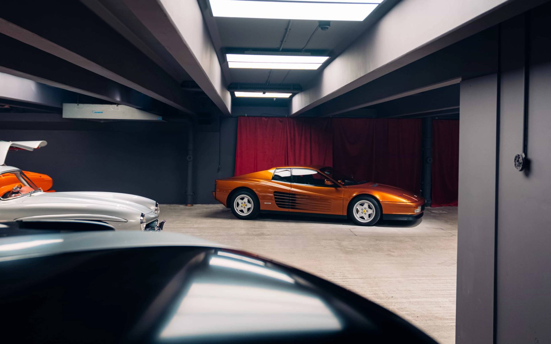 Bronze classic sports car parked in an underground concrete bunker film location in Brentford TW8 by Love Locations.