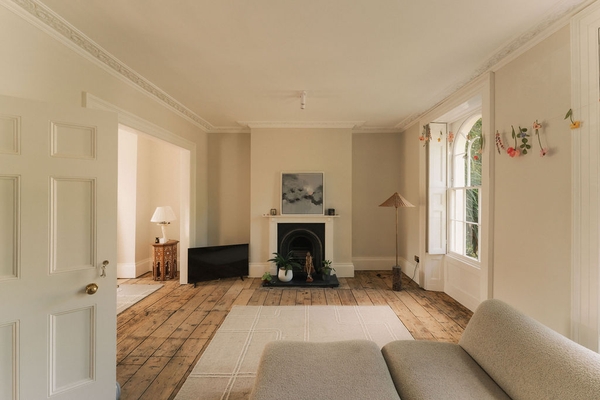Spacious open-plan living room shoot location in Stockwell, SW9 featuring original wooden floorboards, a classic fireplace, and neutral styling, ideal for home lifestyle brand campaigns via Love Locations.