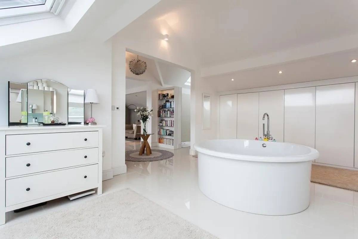 Luxury open-plan master bathroom location house in Stockport SK6 through Love Locations, featuring a modern round freestanding bathtub.
