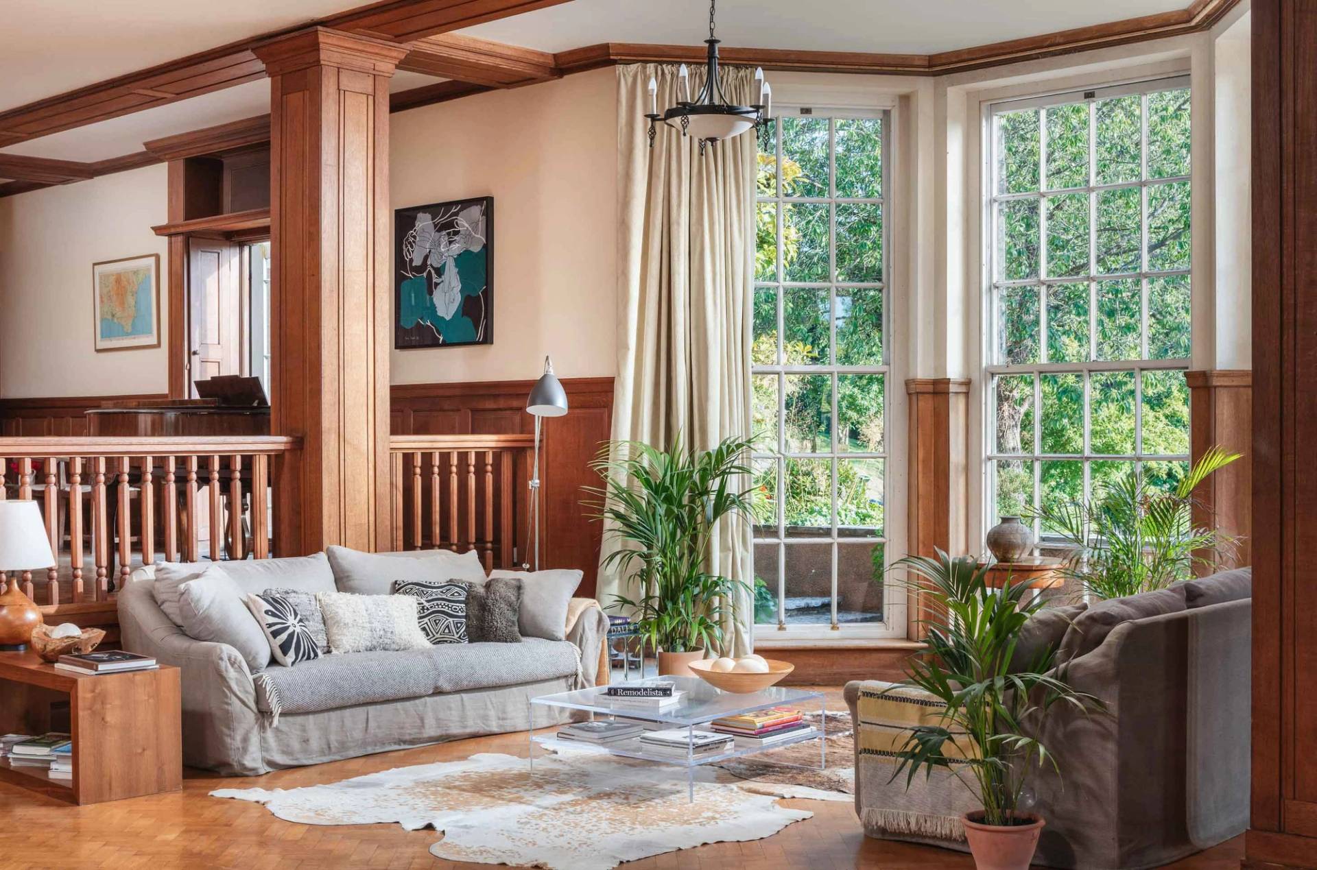 Spacious drawing room photoshoot location with grand sash windows, indoor plants, and plush sofas in Devon from Love Locations.