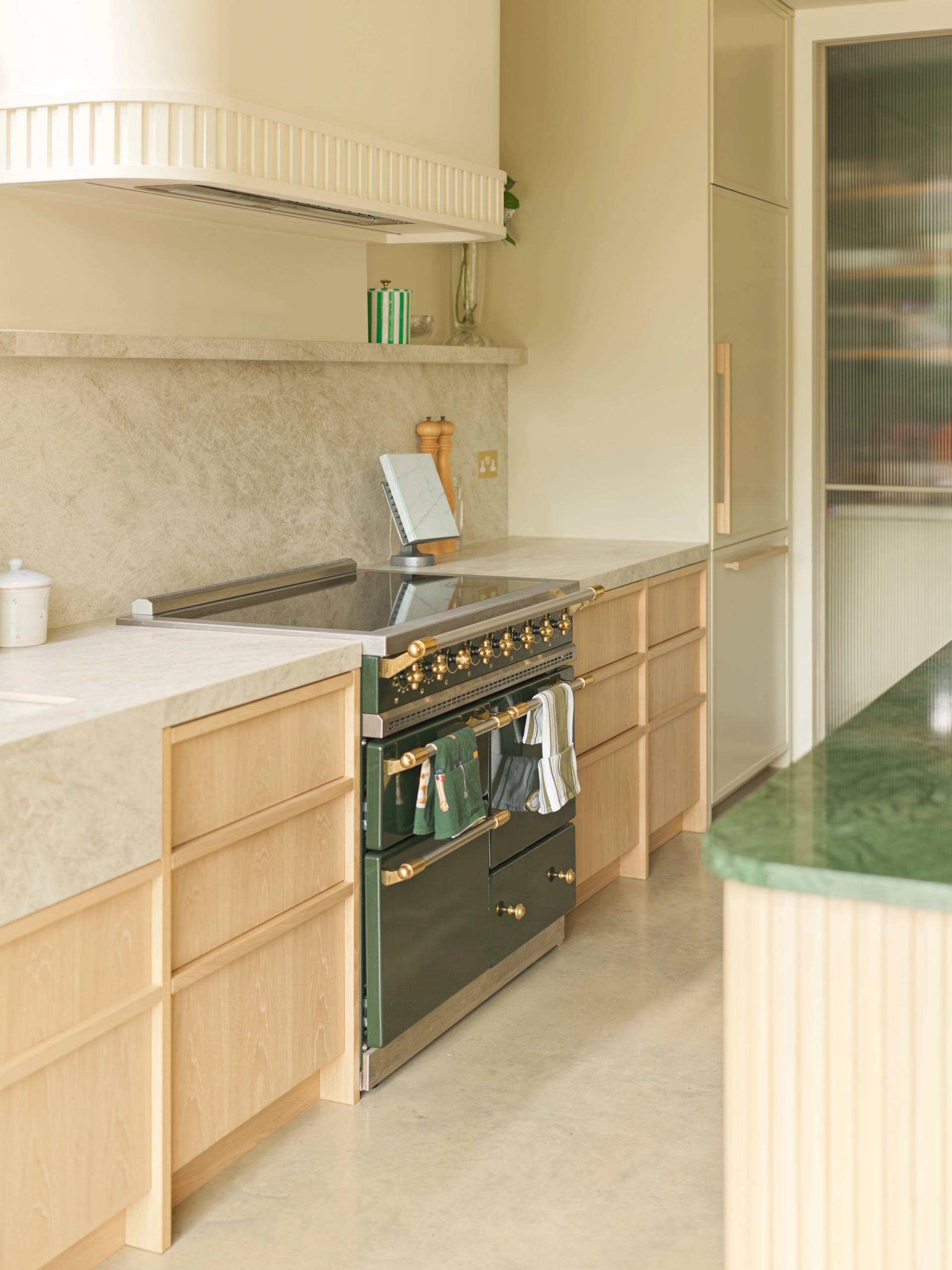 Luxury range cooker setup with marble backsplash and light oak lower cabinets in a Clapham South location house by Love Locations.