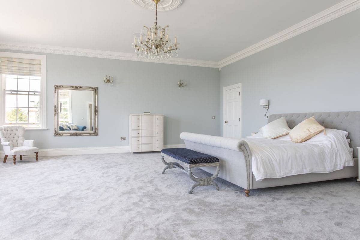 Grand master bedroom with a silver sleigh bed, crystal chandelier, and classic Georgian proportions, hire via Love Locations, RH17.