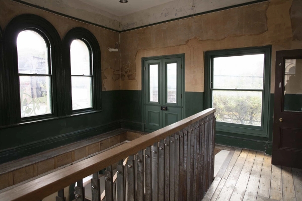 Industrial spiral staircase inside the Love Locations Old Waiting Room, a derelict Peckham Rye venue available to hire for photoshoots, art exhibitions, and private events in South East London.