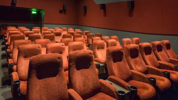 Side perspective view showing rows of plush red velvet theater seats and dark acoustic wall panels inside The Ritzy Screen 4 shoot location in Brixton SW2 through Love Locations.