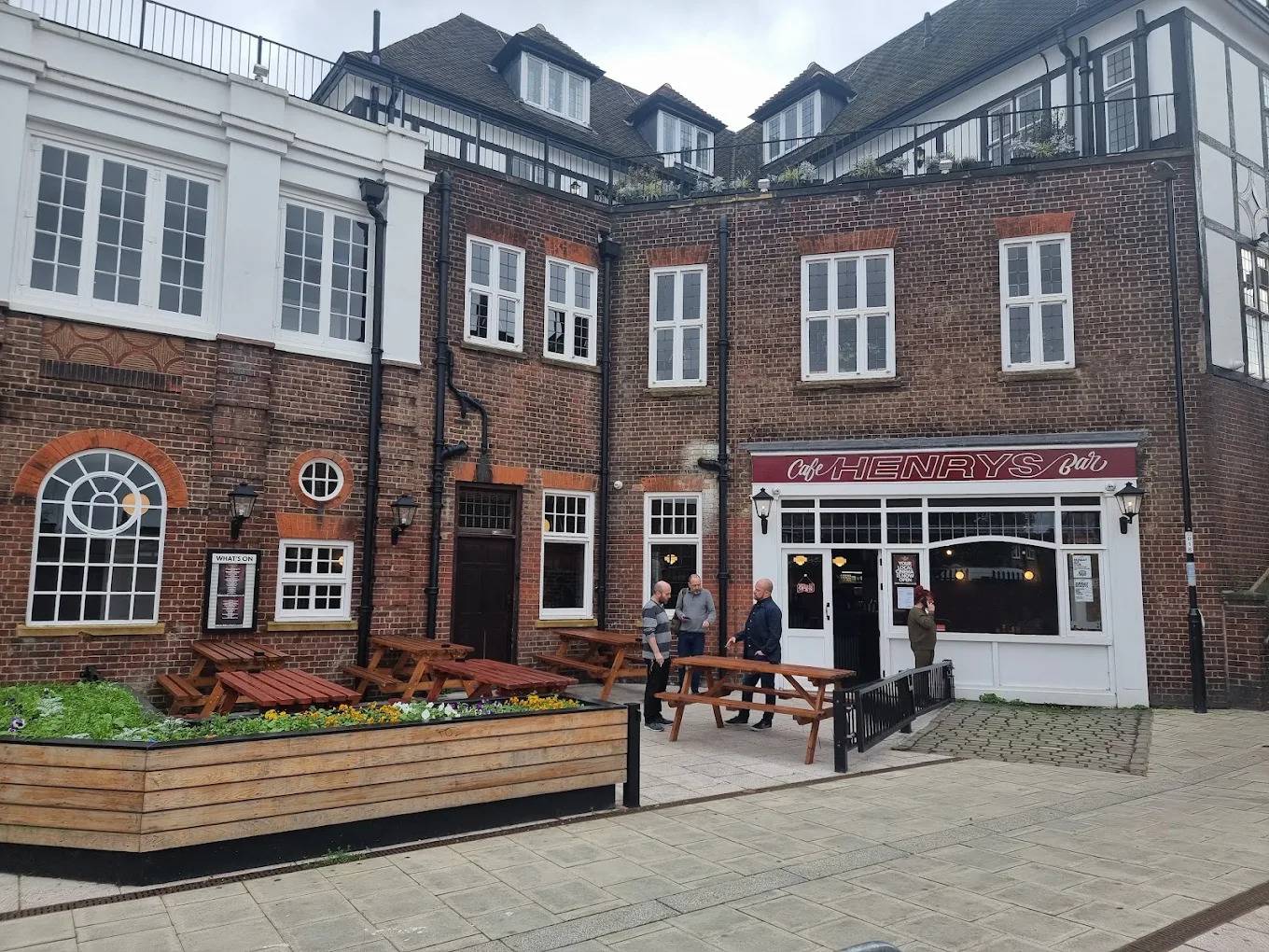 Exterior courtyard and brick building facade of The Fellowship Inn pub and cinema venue in Lewisham SE6 via Love Locations.
