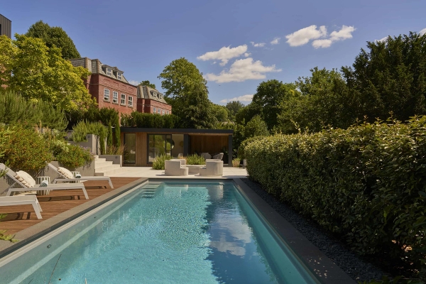 Stunning resort-style outdoor swimming pool and modern brick mansion exterior for film production, Love Locations.