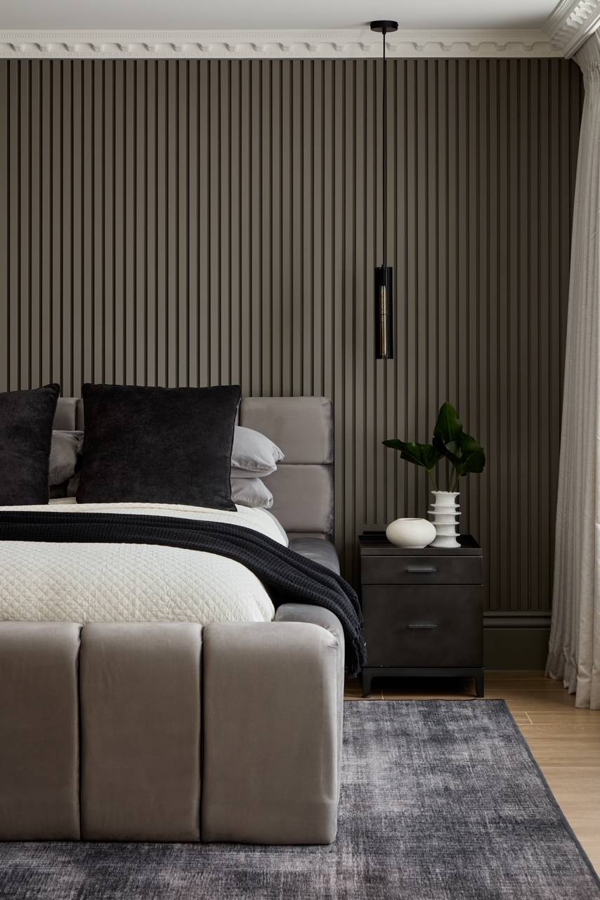 Modern bedroom shoot space featuring a grey fluted panel accent wall, premium bedding, and minimalist nightstands, ideal for contemporary interior shoots, Love Locations.