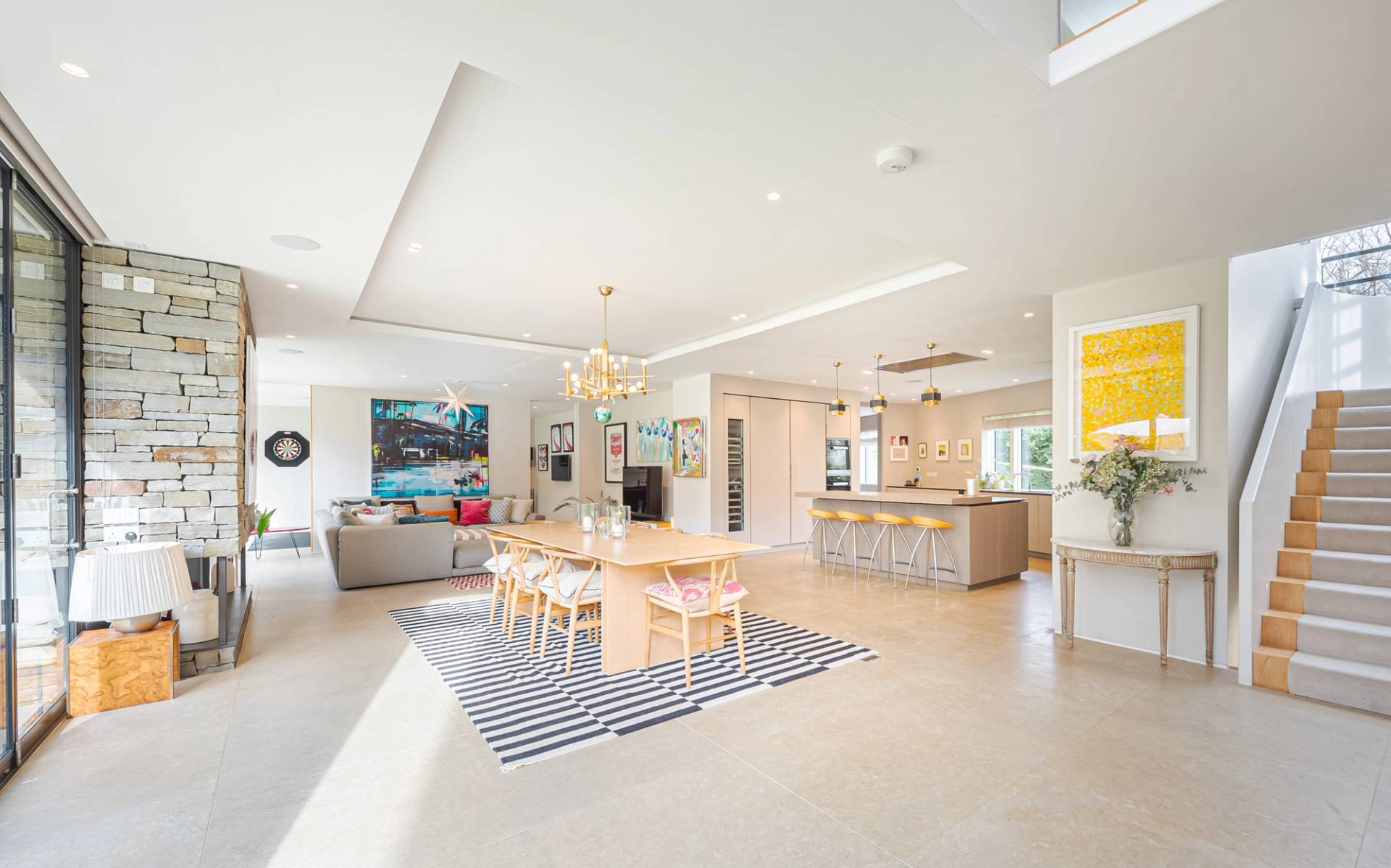 Spacious open-plan reception room with polished flooring, light oak dining table, and floor-to-ceiling glass patio doors in Kingston upon Thames, Love Locations KT2.