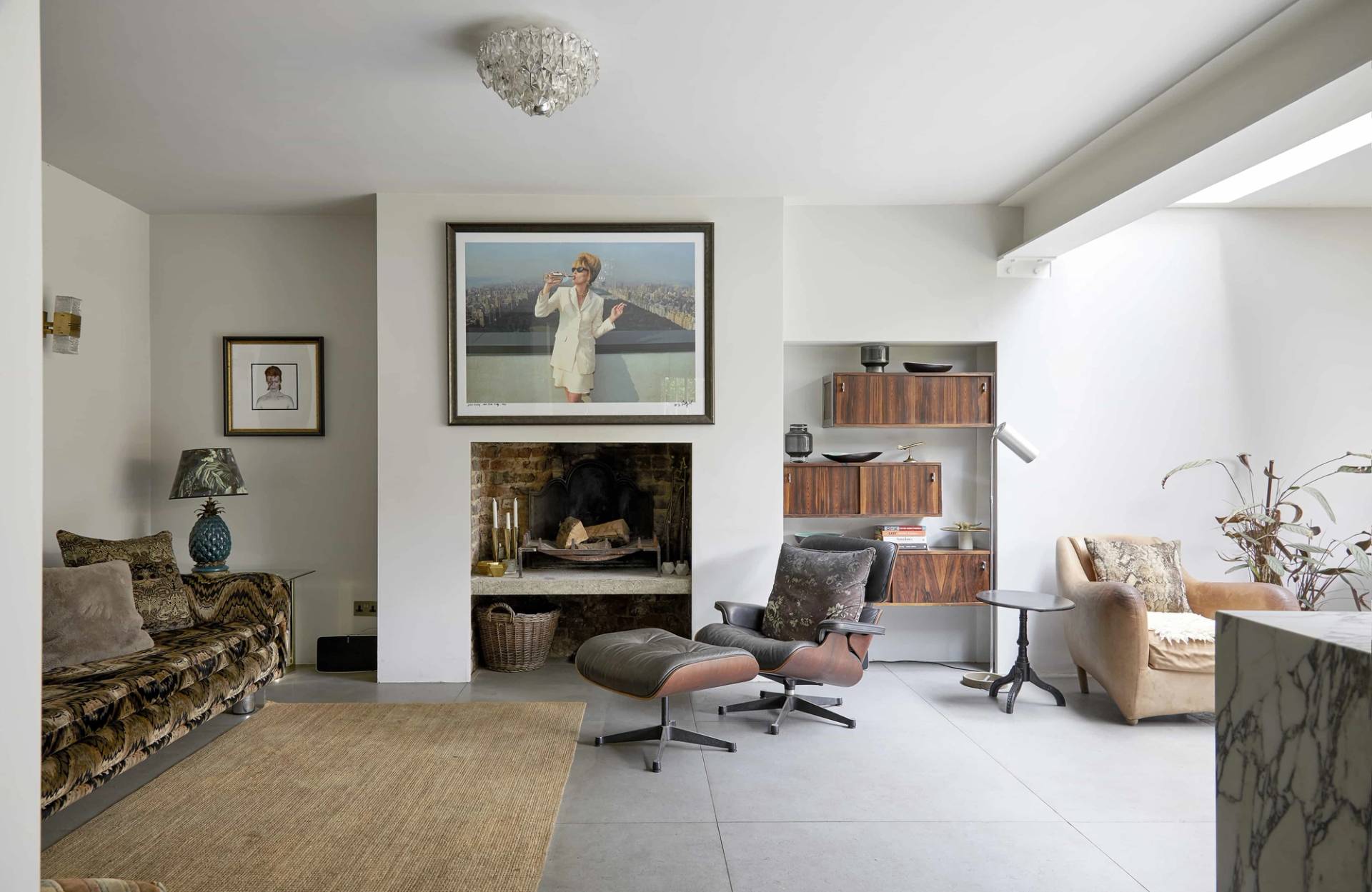 Modern ground floor extension featuring an inset wall fireplace, Eames lounge chair, and polished concrete floor, Love Locations N16.