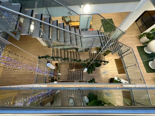 Architectural overview showcasing a striking metal staircase with cascading waterfall-style pendant lights.