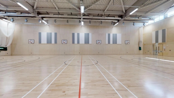 Large indoor school sports hall location with line markings for basketball and netball, listed exclusively on Love Locations.