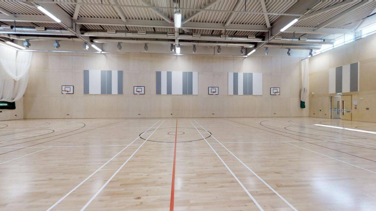 Large indoor school sports hall location with line markings for basketball and netball, listed exclusively on Love Locations.
