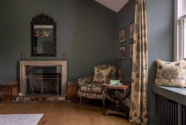 Glenstriven estate lounge with oak floor, fireplace and window seat overlooking woodland