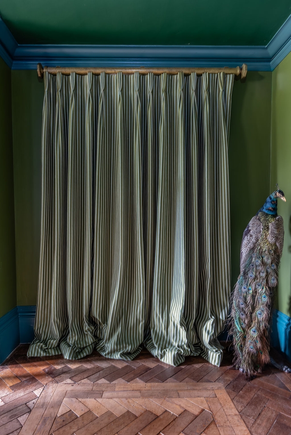 Textural background shot of heavy olive green velvet window curtains draped elegantly, an atmospheric shoot texture by Love Locations.