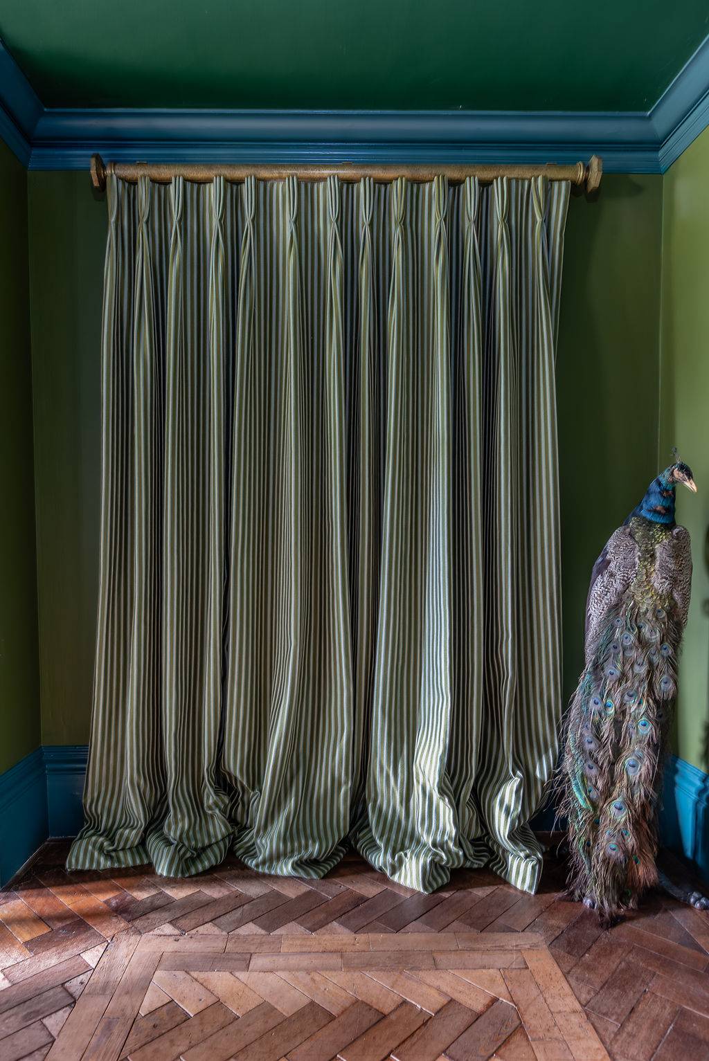 Textural background shot of heavy olive green velvet window curtains draped elegantly, an atmospheric shoot texture by Love Locations.