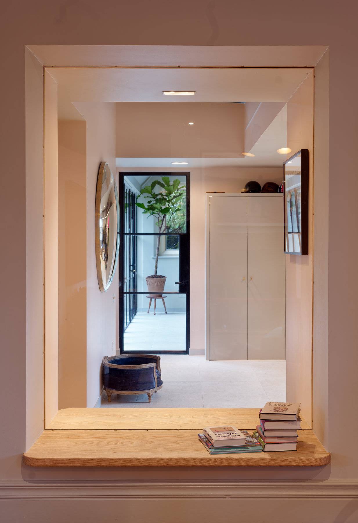 Glass partition doorway looking into a modern pool house changing facility and spa, Love Locations OX7.