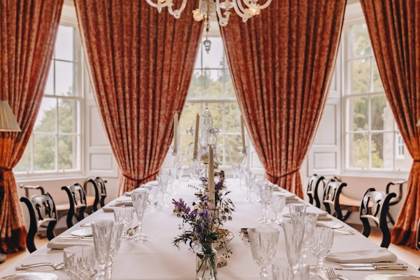 Formal castle dining table setting with red curtains, white linens, and candelabra centerpieces, Love Locations KY15.