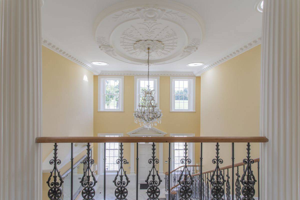 eorgian balustrade and mezzanine gallery looking down towards a grand chandelier, perfect photography location via Love Locations, RH17.