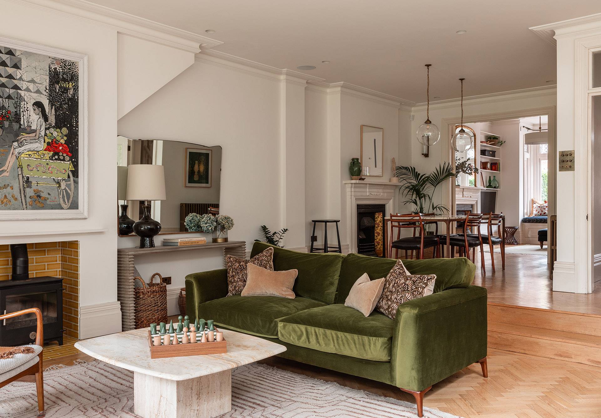 Spacious living room featuring a plush olive green velvet sofa, marble coffee table, and warm natural lighting, perfect for high-end sofa commercials, Love Locations TW1.