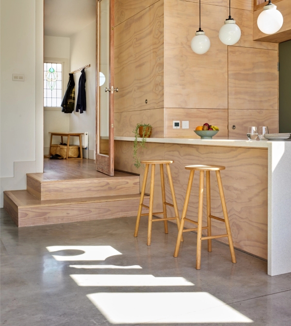 Split-level living space step transition from concrete kitchen floor to timber staircase landing, Love Locations E17.