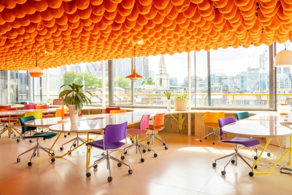 Modern open plan workspace with distinctive yellow ceiling and collaborative seating in Whitechapel London – love locations