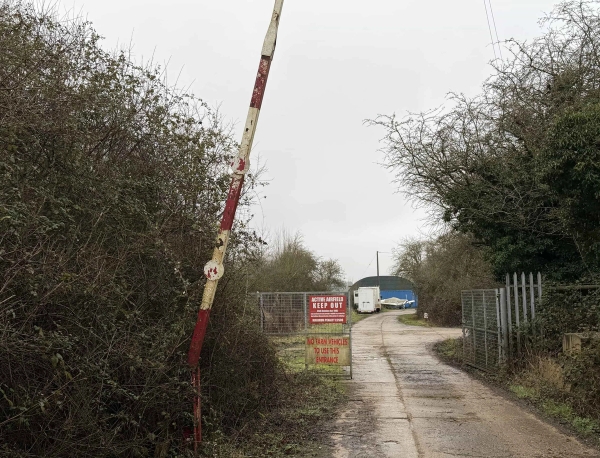 Security gate and restricted access track leading to historic airfield and woodland structures, perfect for unit base management, Love Locations.