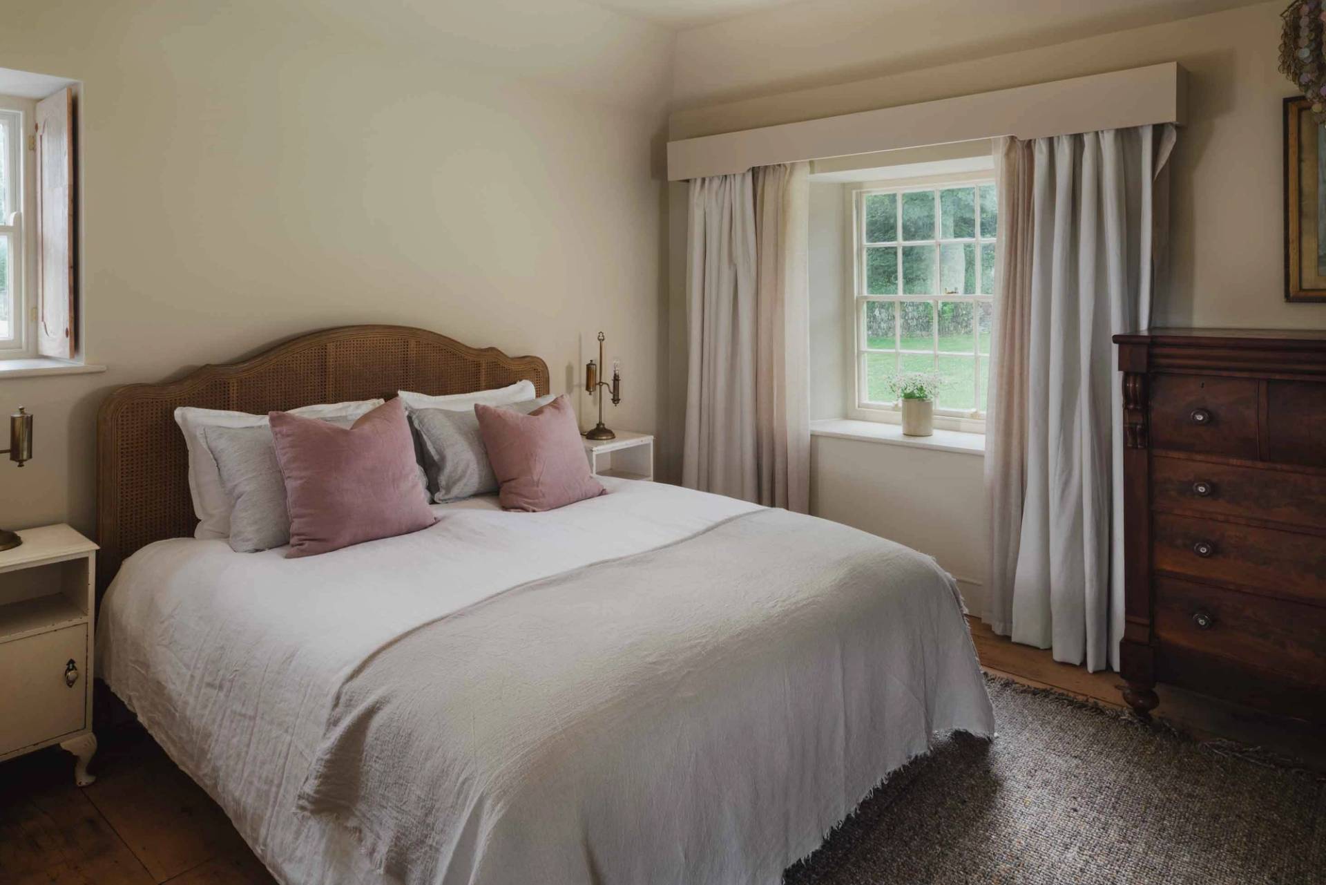 Soft neutral guest bedroom photoshoot location in Newquay Cornwall TR8 from Love Locations, featuring pink velvet accent pillows and sash windows.