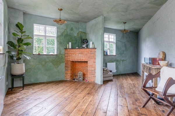 Spacious living room with original fireplace and rustic wooden flooring at Love Locations property in Liss, Hampshire GU33.