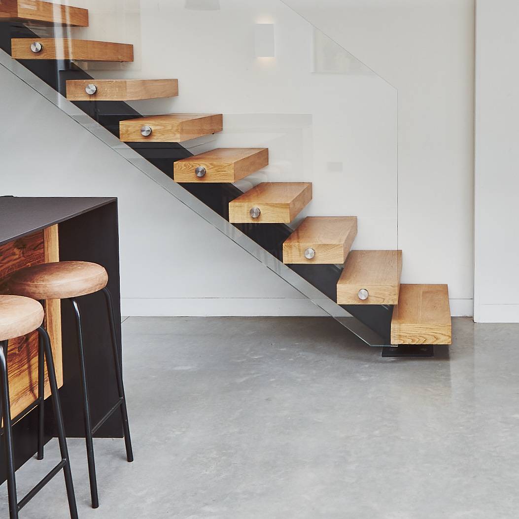 Bespoke floating wooden staircase with glass balustrade set on polished concrete floors, Love Locations TW1.