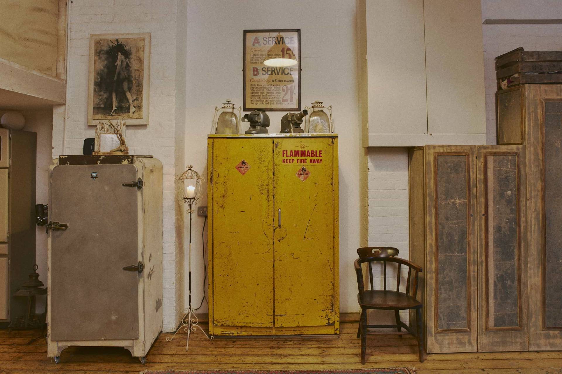Bright yellow vintage industrial cabinet locker paired with a wooden chair and vintage wall poster, perfect for creative photo shoots, Love Locations EN5.