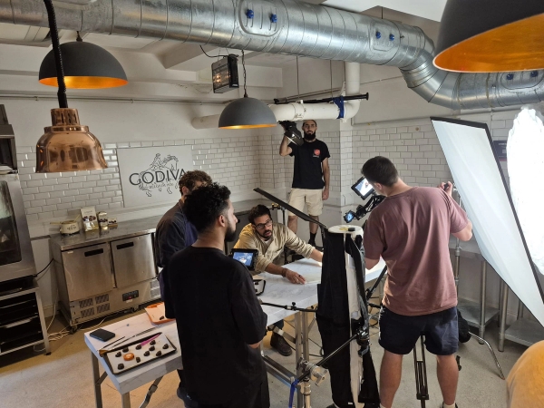 Behind-the-scenes view of a film production crew capturing content inside a professional cooking studio, exclusively on Love Locations.