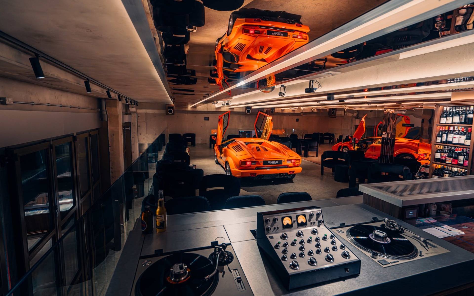 High-end DJ console setup with vinyl turntables and audio mixer inside Plonkers Listening Bar in Brentford TW8 through Love Locations.