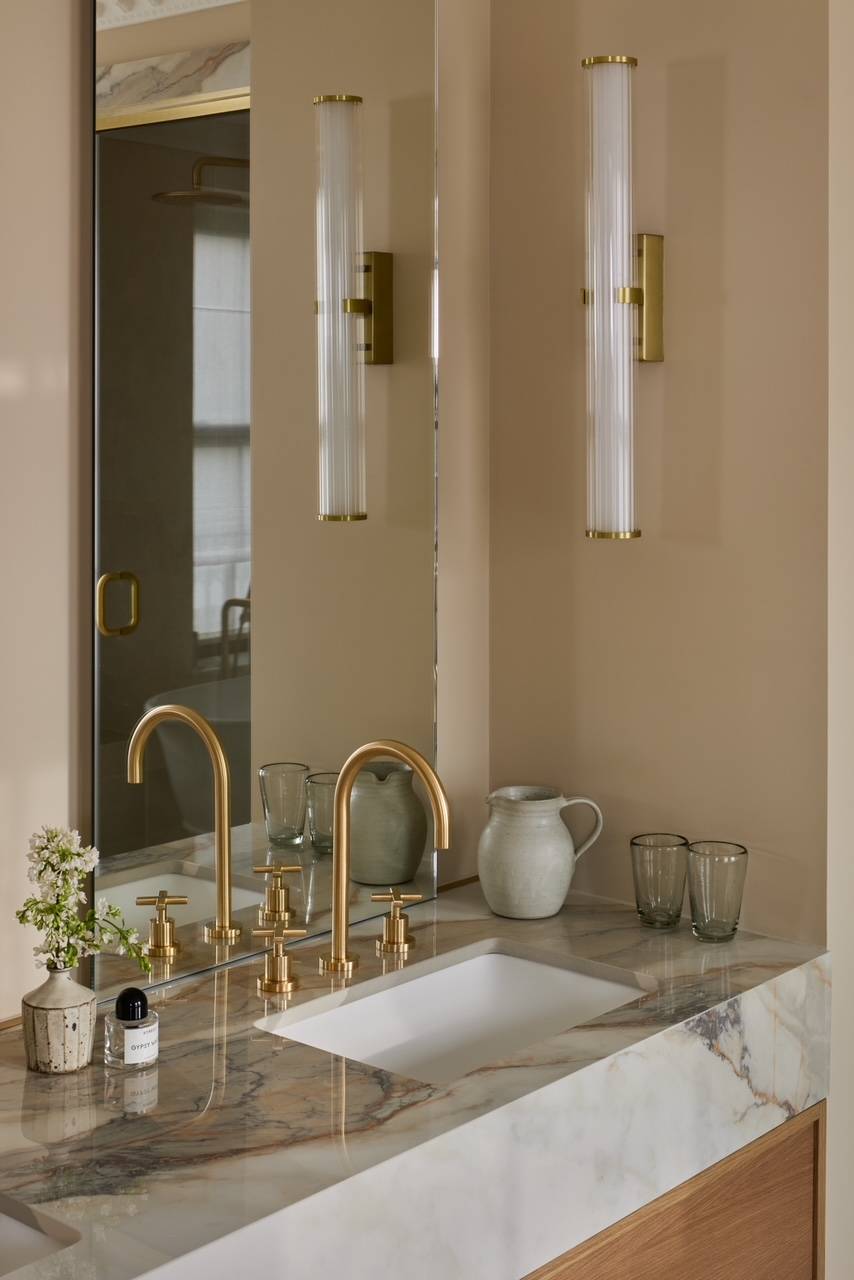 Close-up of a designer bathroom undermount sink with luxury brass hardware and detailed marble grains, perfect for high-end fixture catalogs, Love Locations WD23.