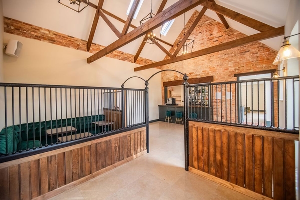 Bespoke equestrian-style stable conversion with exposed brick and vaulted timber ceilings for lifestyle brand shoots, Love Locations.