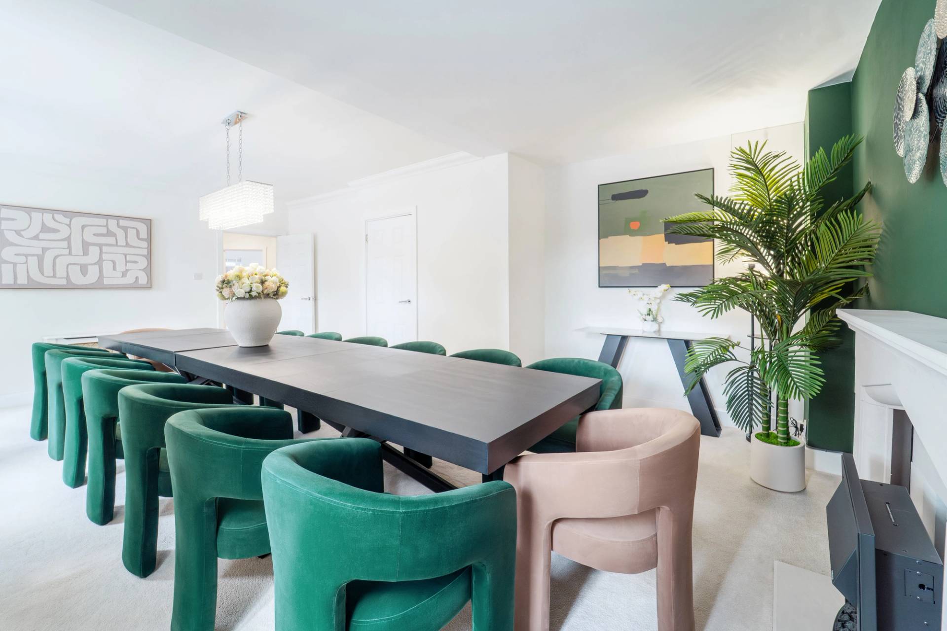 Dining room perspective looking down a long dark wood dining table set with plush velvet chairs, Love Locations RM11.