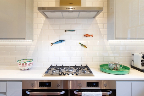 Modern-meets-traditional kitchen stove and extractor fan setup for food photography hire in Westminster SW1V via Love Locations, decorated with decorative wall fish.