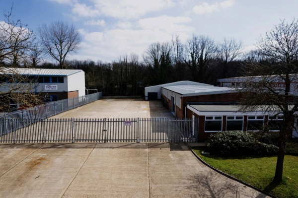 Secure fenced exterior gate, private yard, and commercial gym building exterior in Winchester, SO23, the ultimate unit base and production crew parking location via Love Locations.