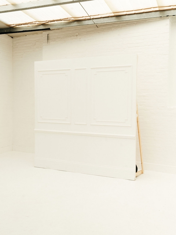Bright white panelled feature wall styled for corporate parties and celebrations at Brixton Warehouse Love Locations.