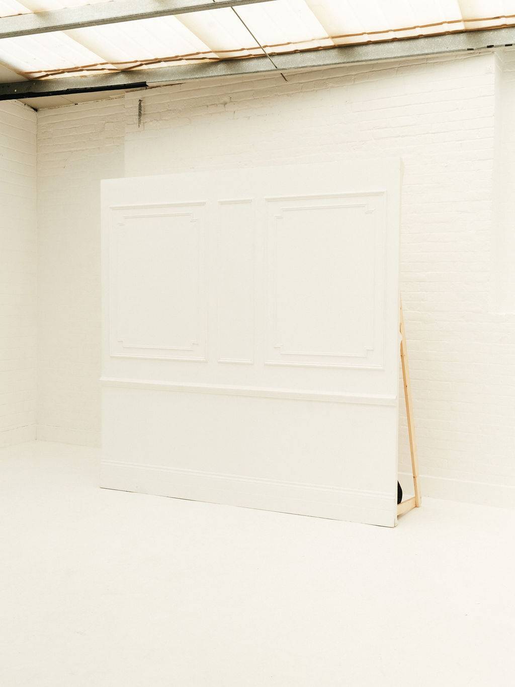 Bright white panelled feature wall styled for corporate parties and celebrations at Brixton Warehouse Love Locations.
