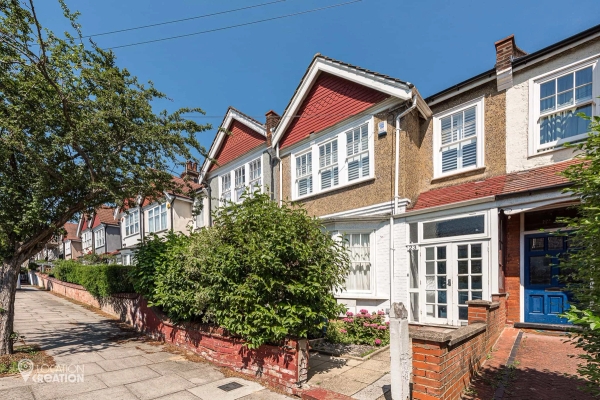 St John’s Avenue traditional British terraced house with red tiled roof, white windows, front garden and leafy residential street – Love Locations property location
