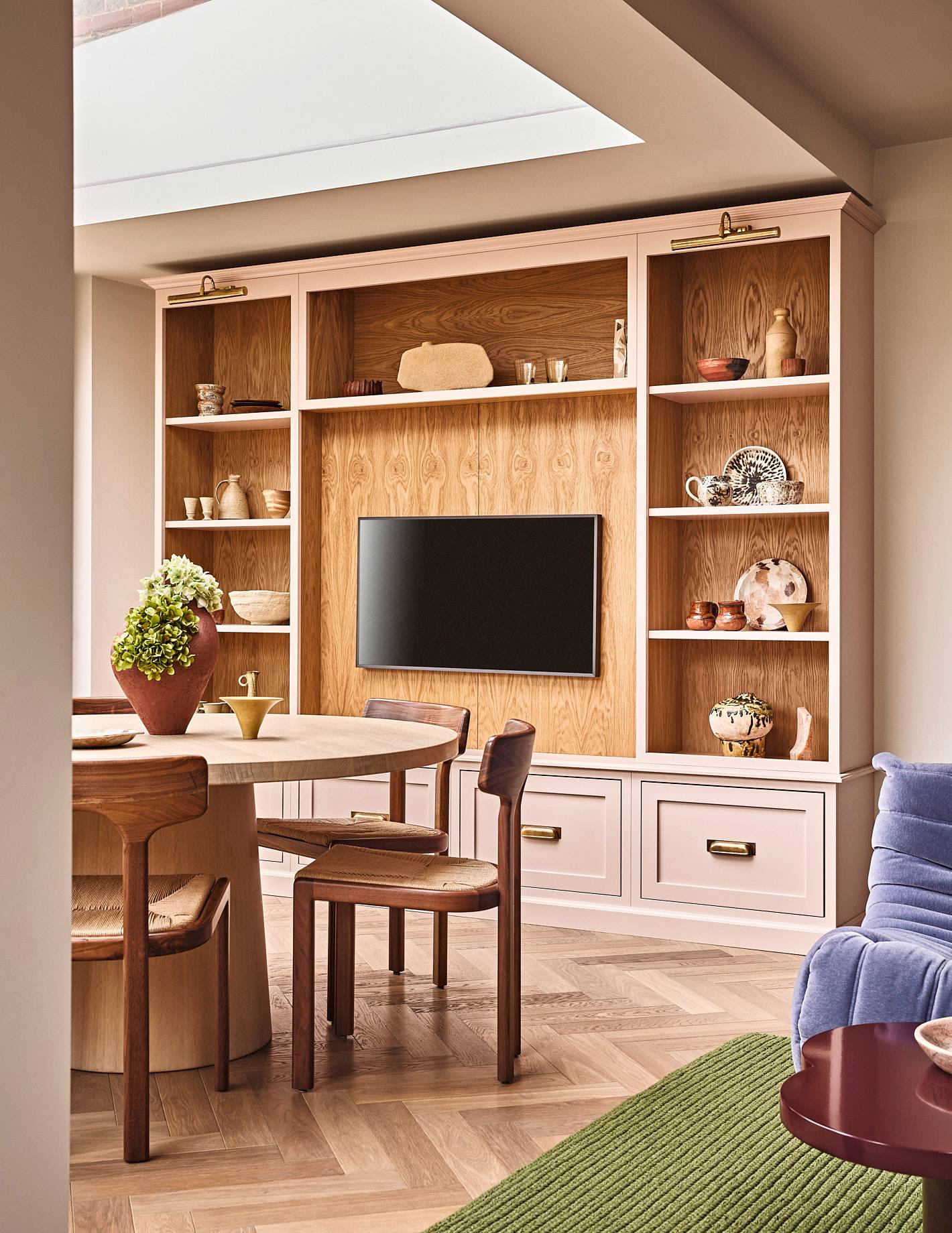 Custom wooden wall cabinetry featuring an integrated TV housing unit and dining area, Love Locations SE21.