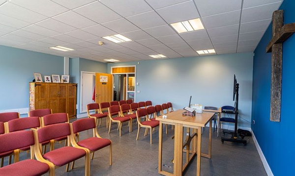 Love Locations modern chapel interior SE2: Brightly lit school chapel room showcasing traditional wooden furniture and clean modern styling, tailored for film crew staging and domestic scenes.