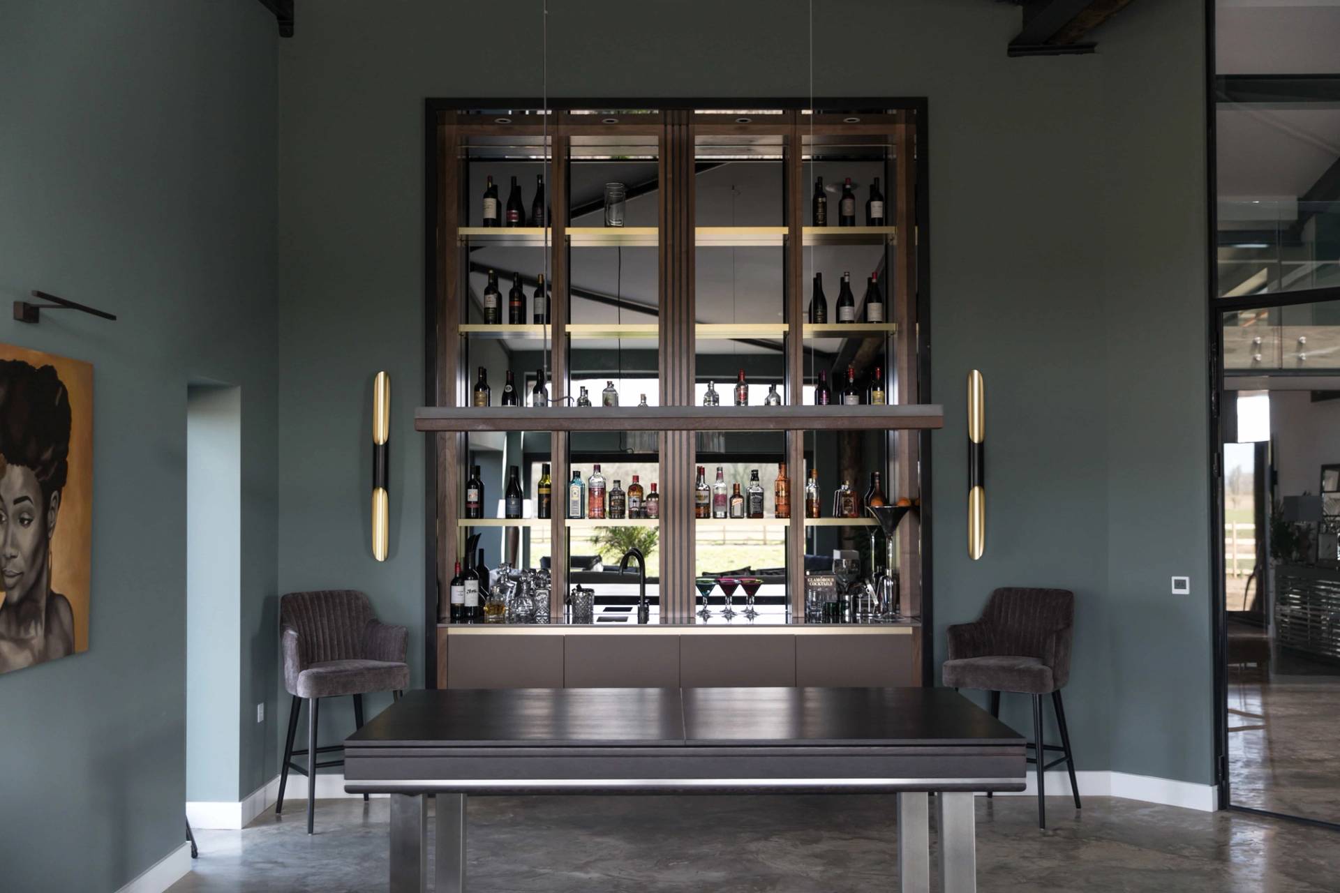 Bespoke built-in home bar cabinet with dark teal panelling, open shelving, and integrated lighting, Love Locations CV23.