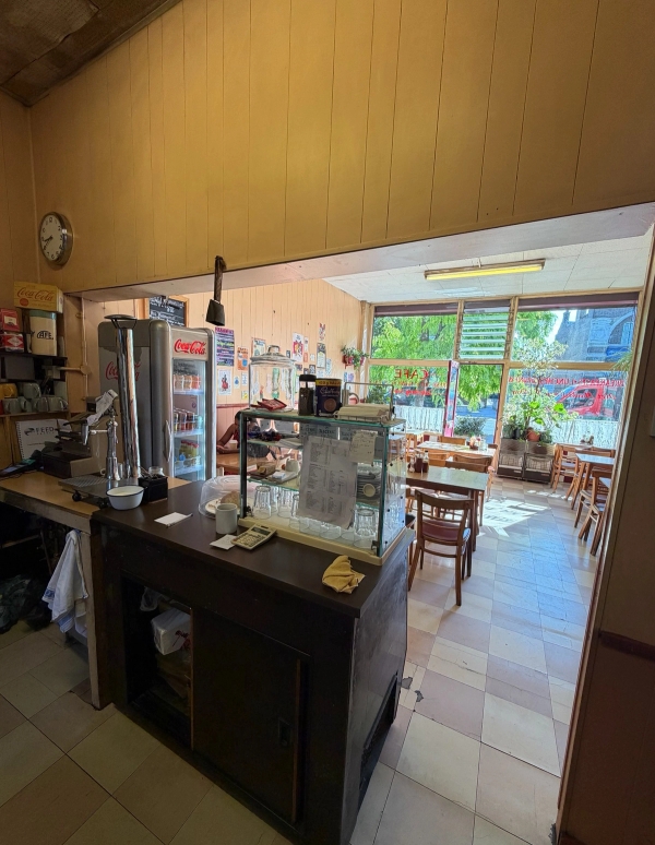 Wide interior shot looking from behind the service counter out toward the main cafe seating dining room, Love Locations SE27.