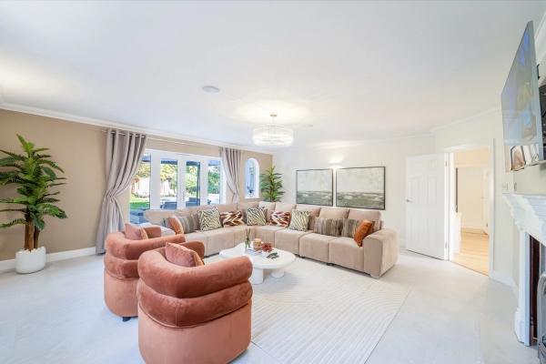 Luxury formal lounge room with terracotta velvet armchairs, large corner sofa, and chandelier, Love Locations RM11.
