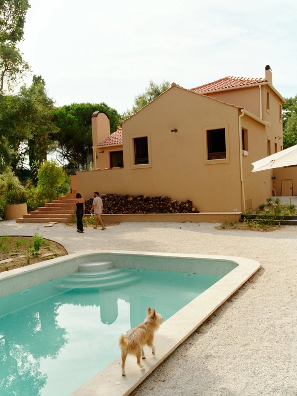 odern ochre villa facade with outdoor swimming pool, terrace patio, and lush forest background, Love Locations 2705-064.