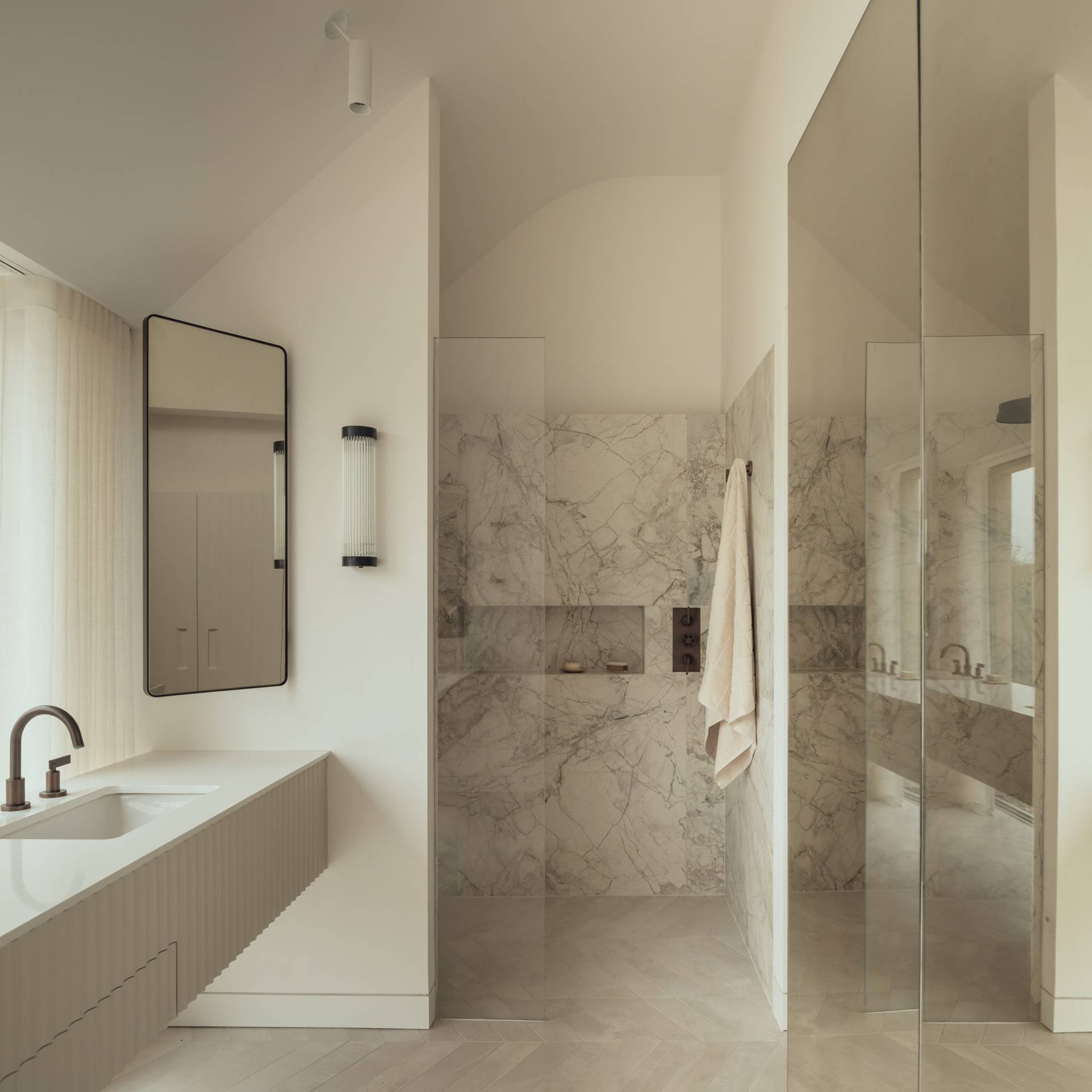 Architectural master ensuite bathroom with a floating stone vanity counter, marble shower walls, and frameless glass partitions, ideal for skincare commercials, Love Locations SO20.