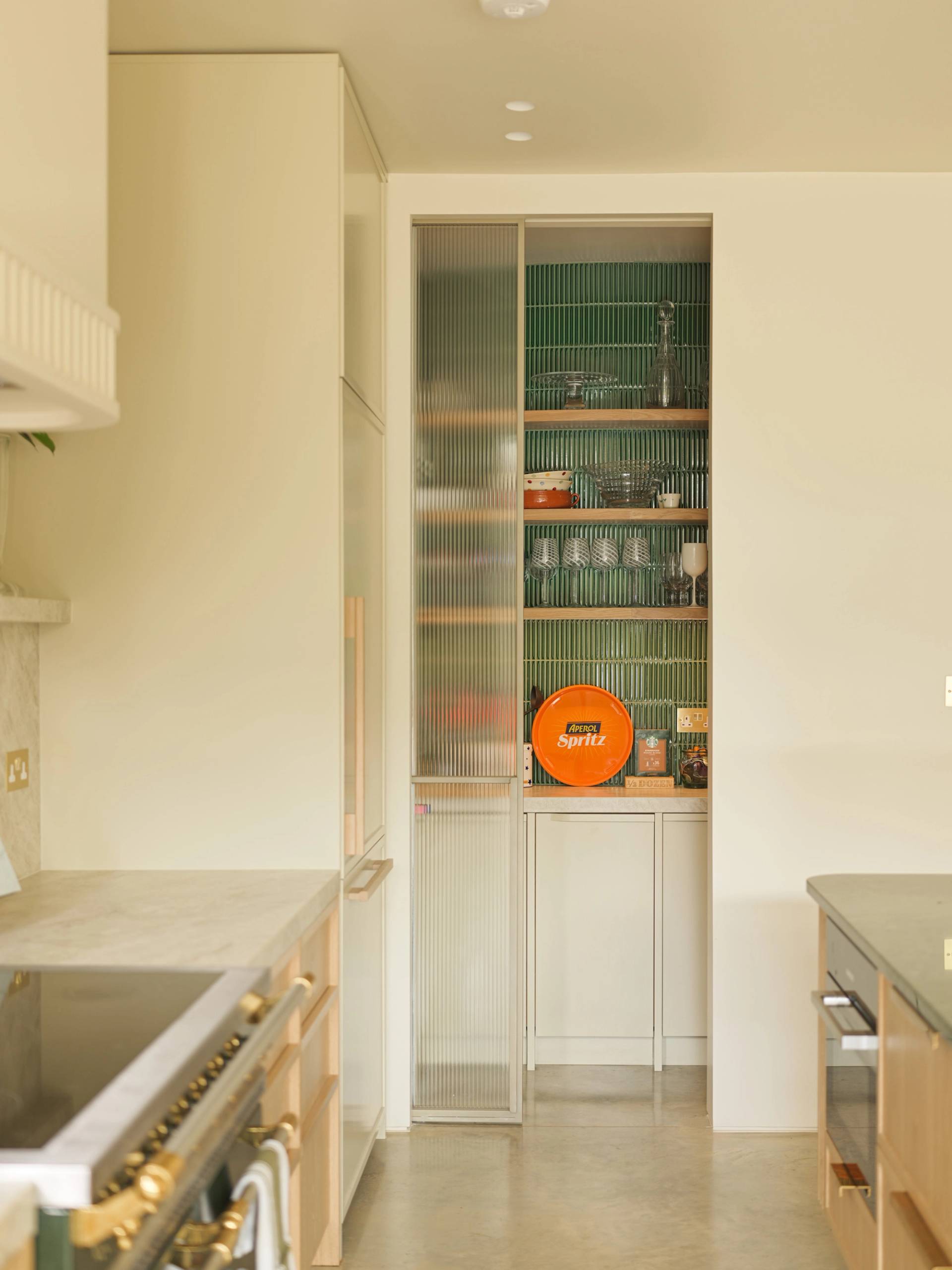 Detail view of a glass-fronted pantry cabinet in a modern South West London shoot house from Love Locations.
