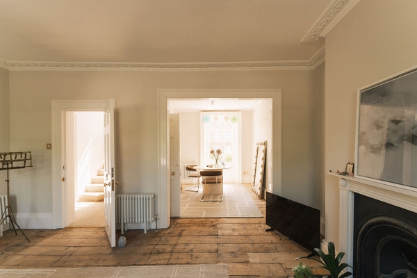 Classic double reception room layout showing authentic wooden floorboards and period architectural details in Stockwell, SW9, Love Locations.