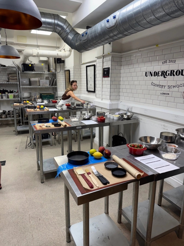 Active kitchen studio space with fresh produce, knives, and ingredients laid out for a commercial cooking production, Love Locations.